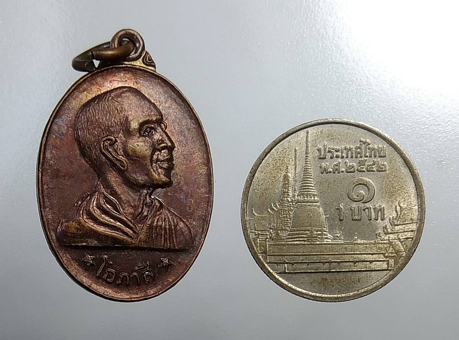 A676 เหรียญหันข้าง หลวงพ่อโอภาสี หลังพญาครุฑแบกพญานาค
