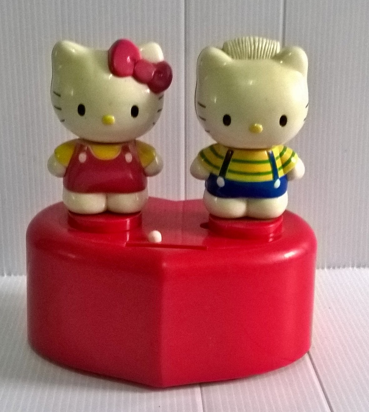 ของเล่น ของสะสมงานเก่า Hello Kitty คิตตี้กับแดเนี่ยล ยืนบนฐานสีแดงรูปหัวใจ สำหรับตั้งโชว์ เครื่องใช้งานไม่ได้ ขนาดประมาณ 13*13 cm. **มีตำหนิตามภาพ