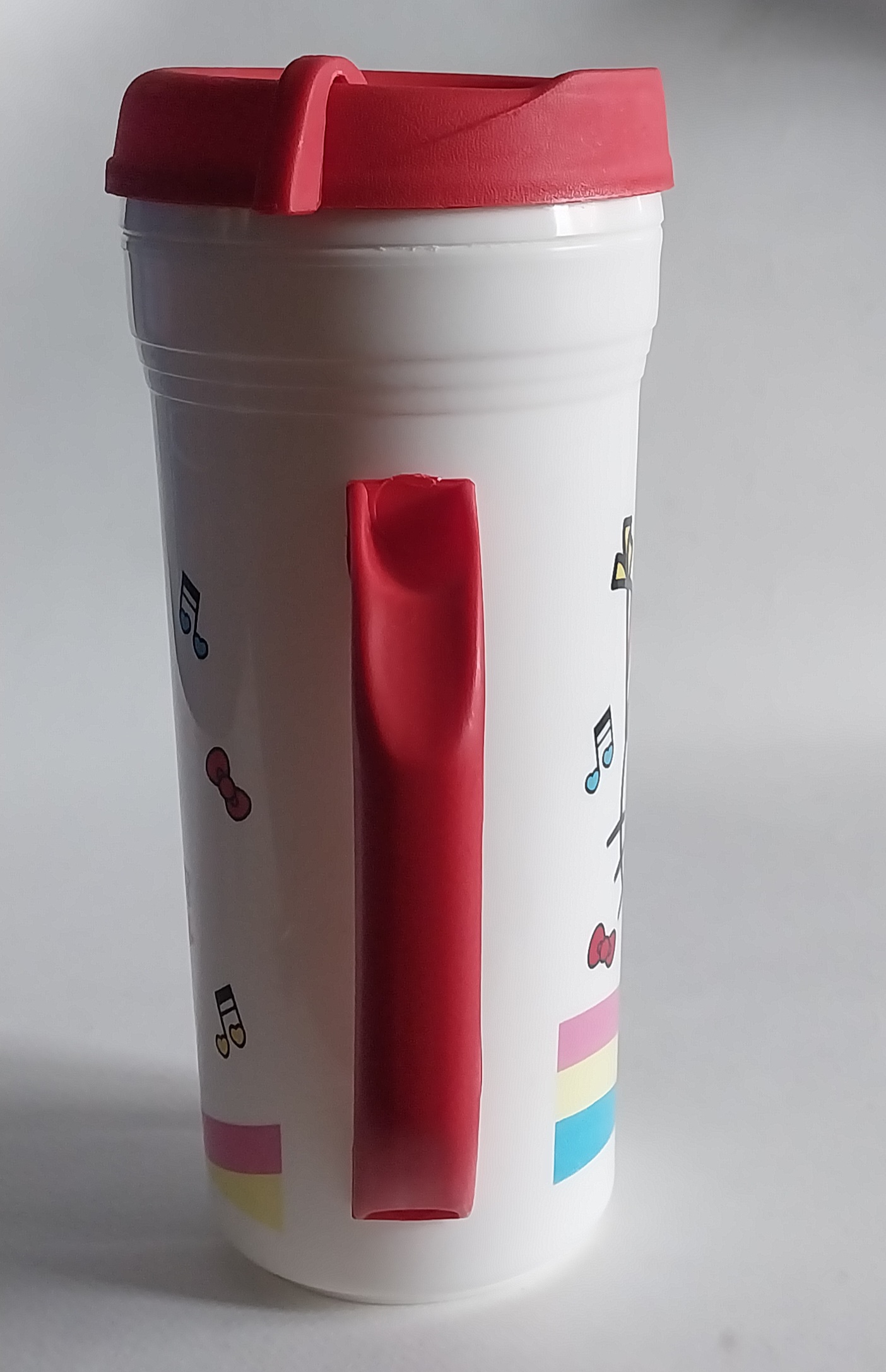 แก้วน้ำพลาสติกสีขาว แดงมีหูจับ ขนาดใหญ่ประมาณ 32 ออนซ์ ลายคิตตี้ใส่เสื้อ7-11 Hello Kitty จาก Sanrio ของสะสมจาก7-11