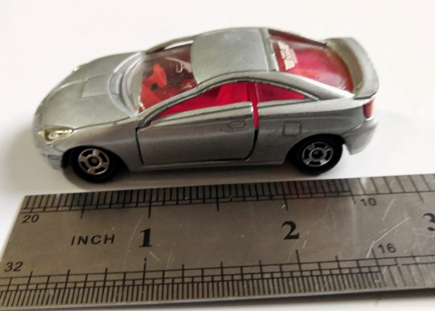 ของเล่น ของสะสม**มีตำหนิ กระจกร้าว ,รถเหล็ก Diecast car รถสปอร์ตสีเงิน เปิดประตูได้ Toyota Celica จาก Tomica