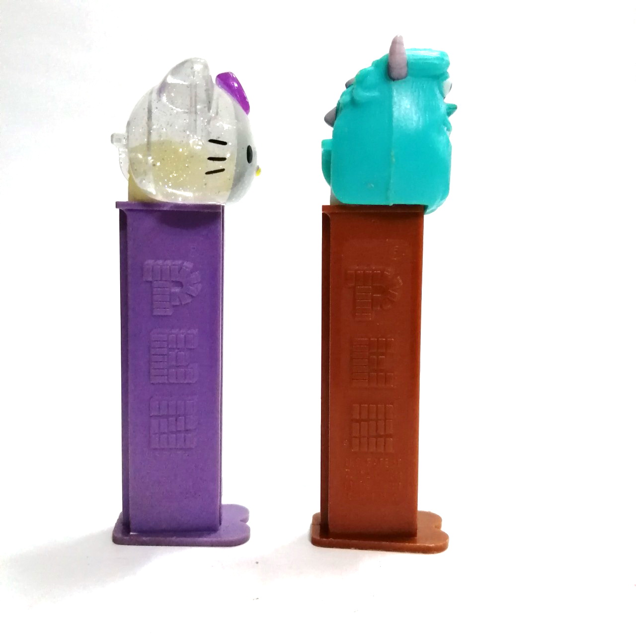 ที่ใส่ขนม PEZ รูป คิตตี้(ใส)และ มอนสเตอร์อินค์ งานเก่าเก็บ ขายตามสภาพ ขายคู่