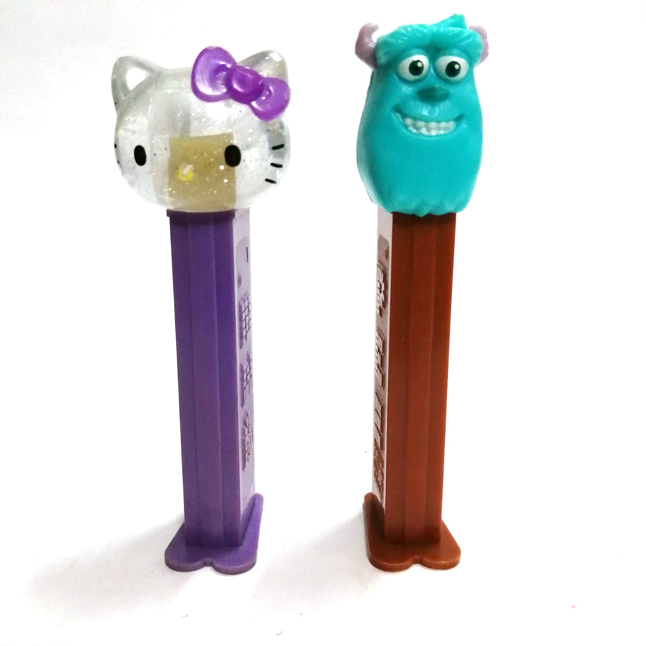 ที่ใส่ขนม PEZ รูป คิตตี้(ใส)และ มอนสเตอร์อินค์ งานเก่าเก็บ ขายตามสภาพ ขายคู่