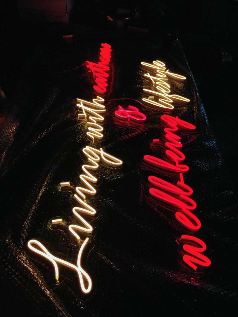 ป้ายไฟนีออนดัด แสงสีแดง&สีเหลือง วางบนอะคริลิคใส