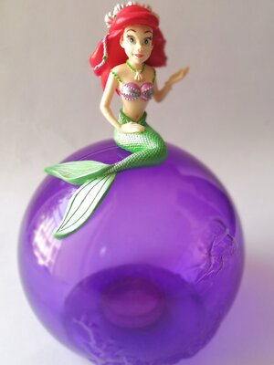 ของสะสม **ไม่มีก้นกระปุก และมีตำหนิ โปรดดูทุกภาพ, ของสะสมจากธนาคารไทยพานิชย์ เจ้าหญิงเงือกน้อย the Little Mermaid, แอเรี่ยล Arial ลิตเติ้ลเมอร์เมด เป็นกระปุกออมสิน แอเรี่ยลนั่งบนระปุกทรงกลมสีม่วงใส สูงประมาณ 7.5" กว้างประมาณ4.5" ดิสนีย์ปริ๊นเซส